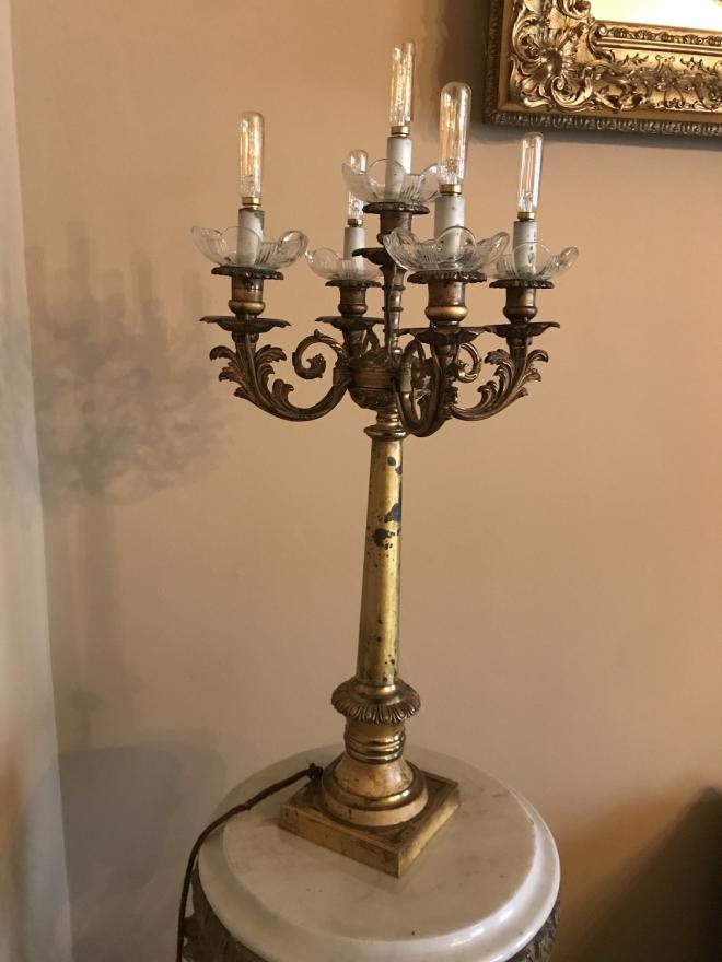  electrified high gilt bronze candelabras with five candle holders on each with glass boubeches.  The candle holders spring from a square gilt bronze base in scroll patterns.