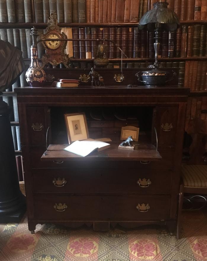American Federal desk This American Federal drop panel mahogany desk has three small drawers on top, three large drawers at the bottom, a key cupboard on the right side, and a drawer of same size on the left with brass drawer pulls.