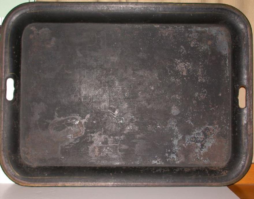 Large tin serving tray with bevelled edge.