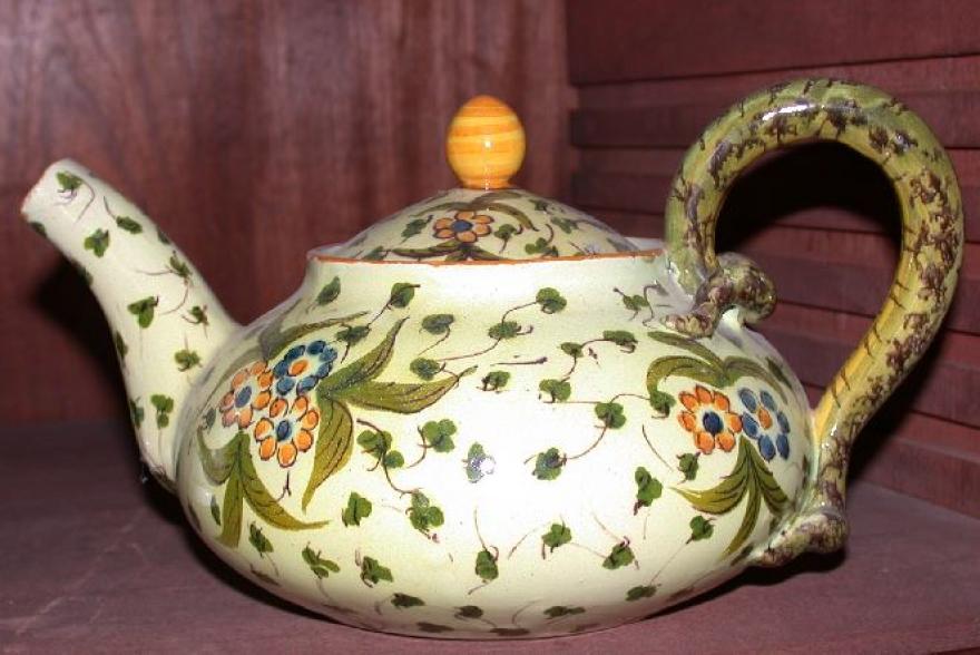 Light green with darker green designs and floral patterns.  Handle in form and color of snake.
