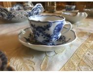blue and white floral design tea cup sitting in a saucer
