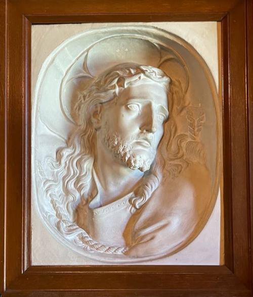 Plaster bas relief of Guido's Ecce Homo.  Wooden frame set into bookcase wall. 
